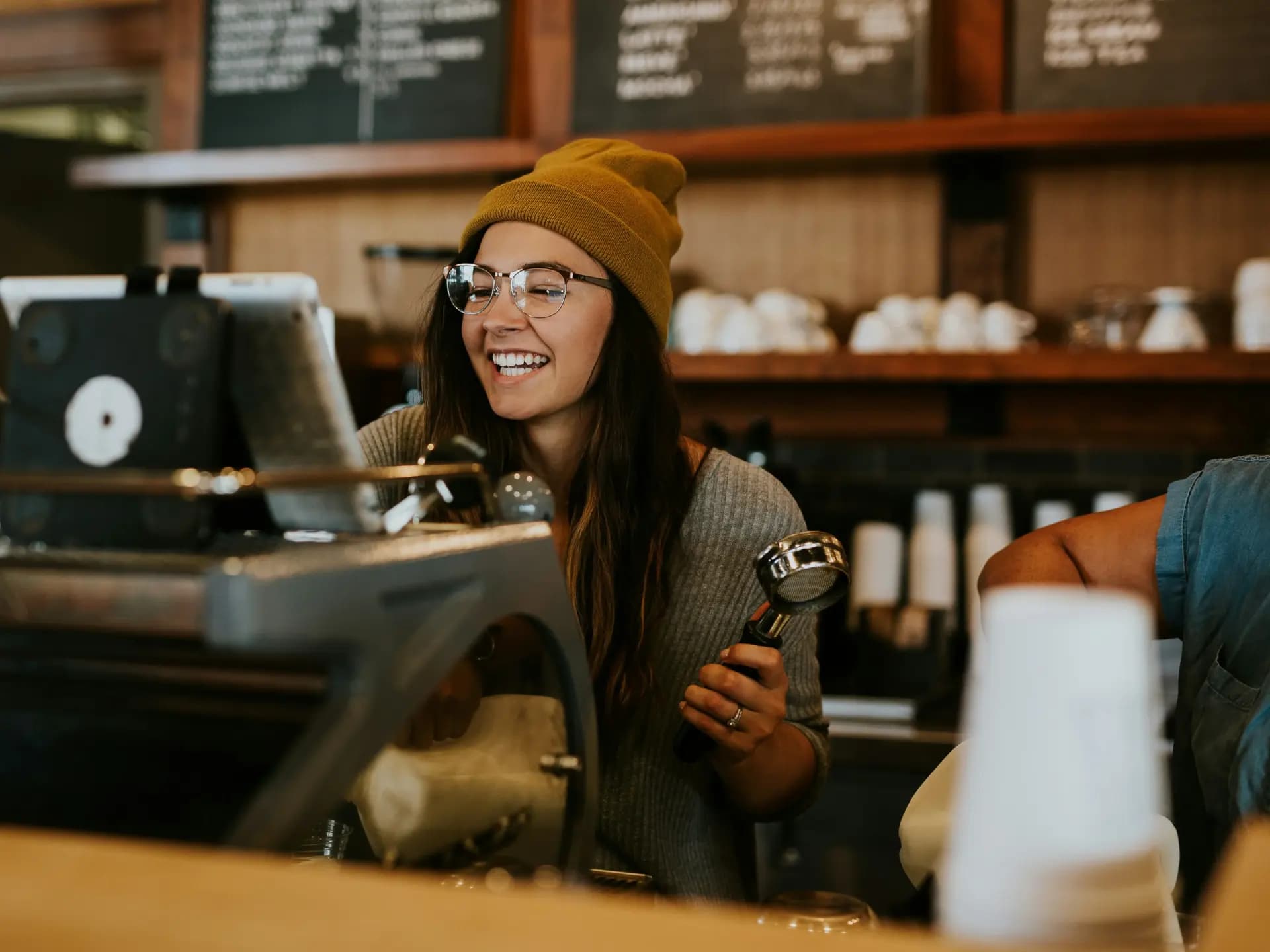 A café team member welcoming guests from behind the counter